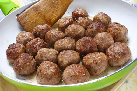 Fried pork meatballs in frying pan 