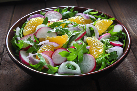 Salad with arugula, radish, red onion and tangerineの写真素材