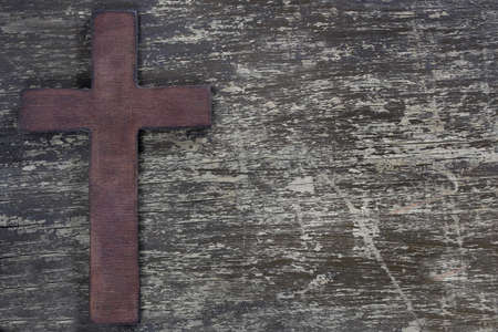 Wooden cross on old wooden boardの写真素材