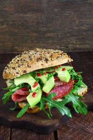 Sandwich with arugula, salami and avocadoの写真素材