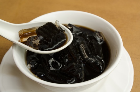 (Choa Kuay) Grass jelly in a cup with ice & syrup ready to delicious in the restaurant.の写真素材