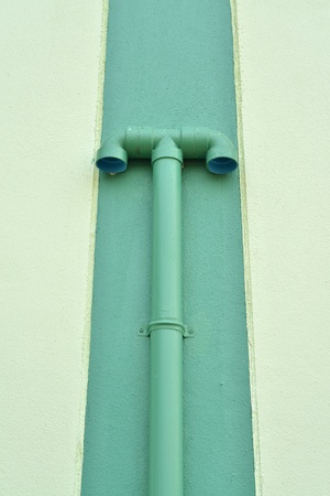 Bathroom ventilation pipes mounted on a wall outside of a gymnasium の写真素材