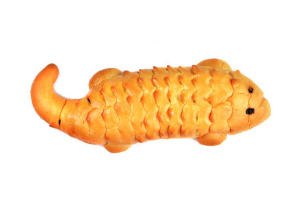 The crocodile shaped bread on white background 