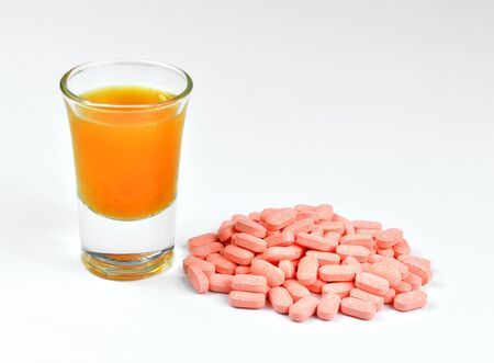 Closeup of vitamin C and orange juice on white background の写真素材