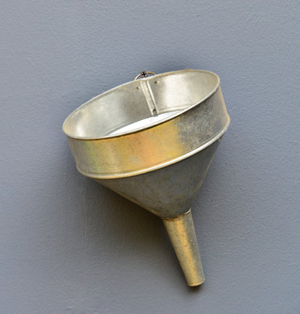 Zinc funnel on gray cement wall の写真素材