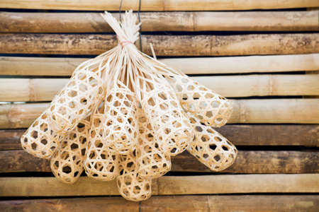Wicker round bamboo baskets on bamboo wall の写真素材
