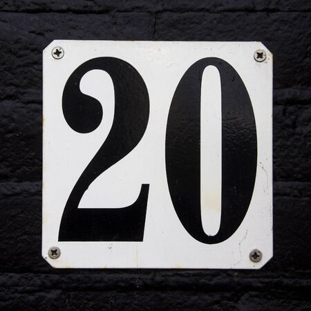 modern house number twenty attached to al black paintedbrick wallの写真素材