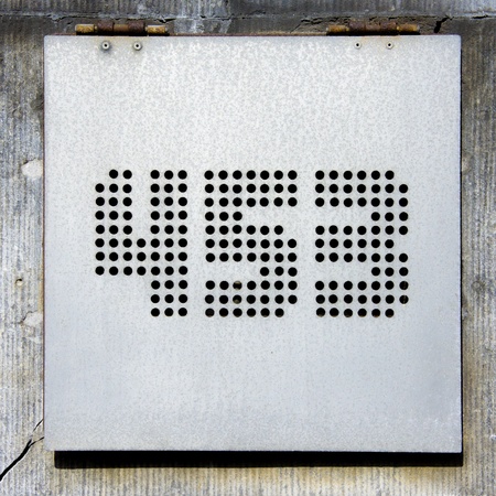 house number ffour hundred fifty-thee, made out of holes drilled in an aluminum plateの写真素材