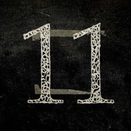 fancy house number eleven on a lacquered black background