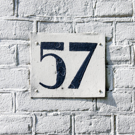House number fifty-seven  Black lettering on a white plate