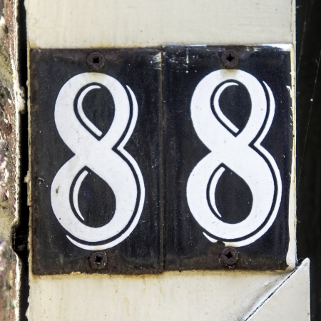 house number eighty-eight on two separate enameled platesの写真素材