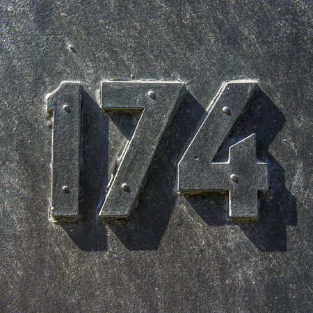 house number hundred and seventy-four  black volumetric lettering on a black background