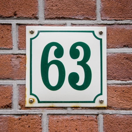green house number sixty-three on an enameled plateの写真素材