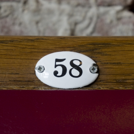 number fifty-eight on an oval shaped shield attached with two screwsの写真素材