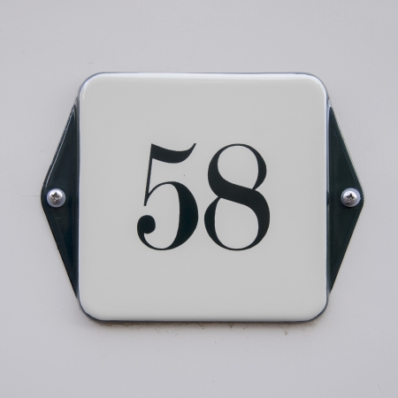 enameled house number fifty-eight. Black lettering on a white background.の写真素材