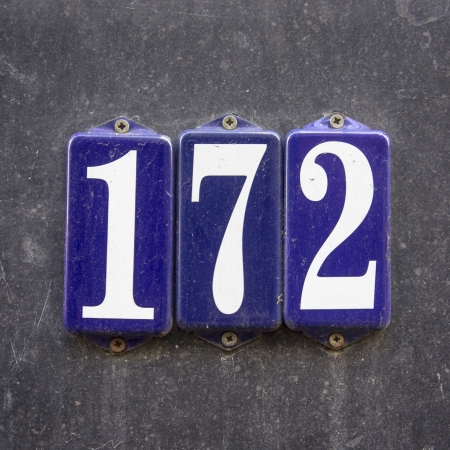 enameled house number one hundred and seventy-two. White lettering on three separate blue shields.の写真素材