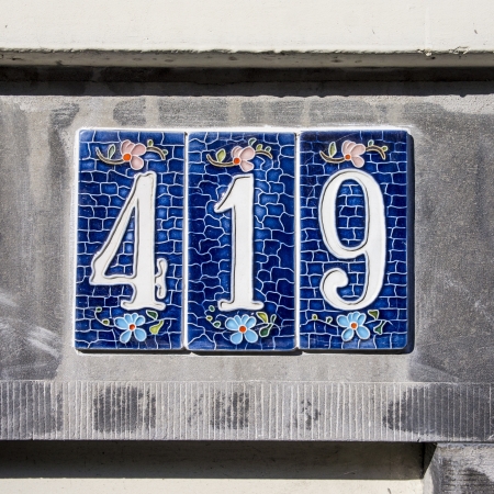 house number four hundred and nineteen on three separate decorative ceramic tilesの写真素材