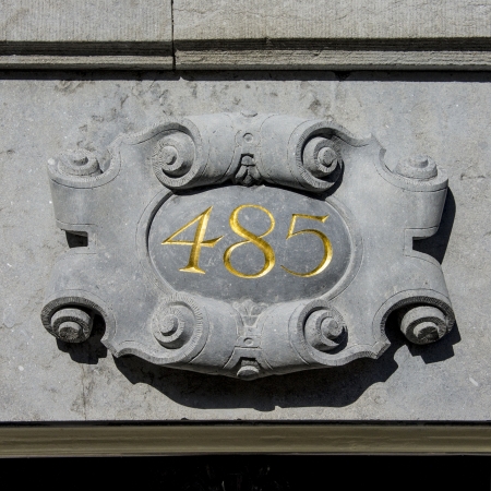 house number four hundred and eighty-five. Gold lettering in a stone ornament.の写真素材