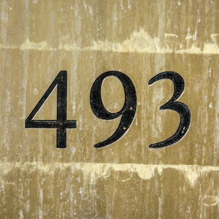 house number four hundred and ninety-three engraved in a brass plateの写真素材