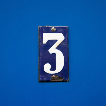 enameled house number thee. White lettering on a blue background