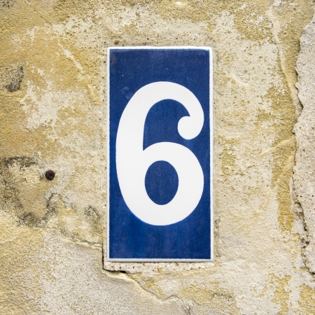 House number six on a ceramic tile  White lettering on a blue backgroundの写真素材