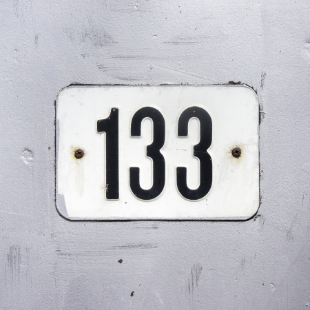 House number one hundred and thirty-three on a silver painted wall の写真素材