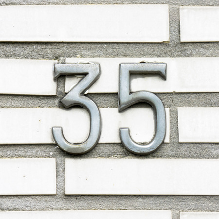 steel hoouse number thirty five consistant of two separate numbersの写真素材