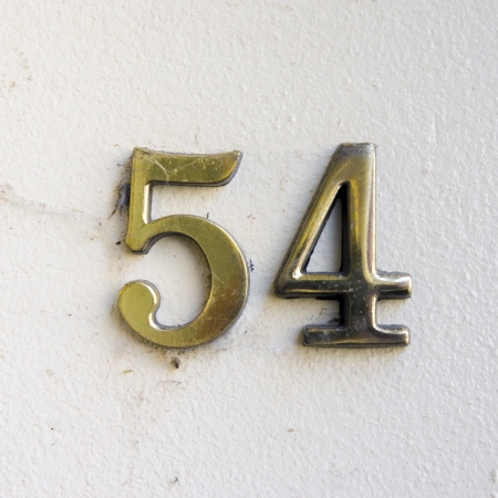 brass house number fifty four on a wallの写真素材