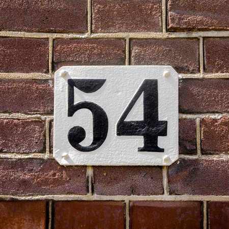 house number fifty four.Black lettering on a white plateの写真素材
