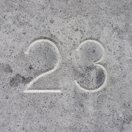 house number twenty three, carved in stone.の写真素材