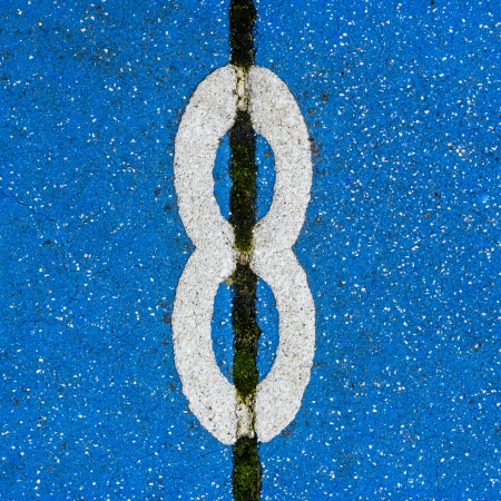 Number eight on colored pavement tiles.の写真素材