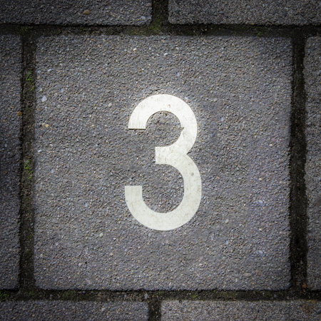 pavement tile with the number threeの写真素材