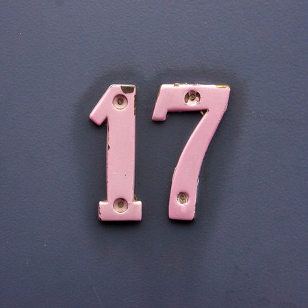 house number seventeen. Pink painted brass numerals.