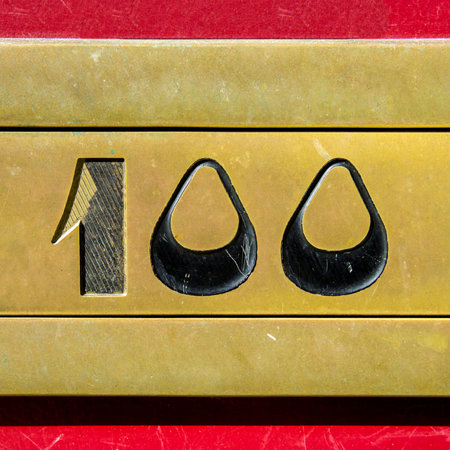 house number one hundred engraved in a bronze plate.