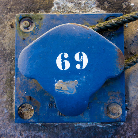number sixty nine on a blue painted metal bollard
