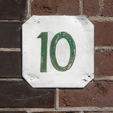 hand painted house number ten. Green numerals on a white backgroundの写真素材