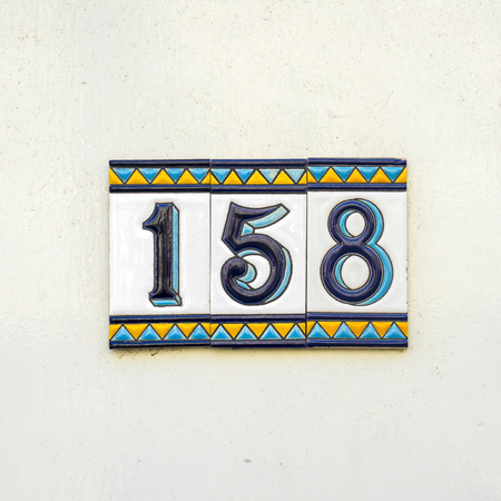 ceramic house number one hundred and fifty eight on three tiles.の写真素材