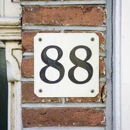 house number eighty eight , black numerals on a white backgroundの写真素材