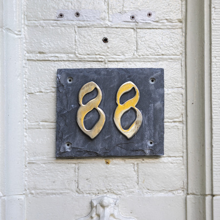 House number eighty eight on a black slateの写真素材