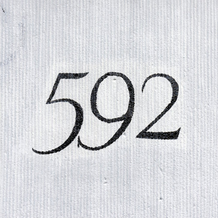 House number five hundred and ninety two. Black numerals on a light background