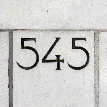 house number five hundred and forty five, carved in stoneの写真素材