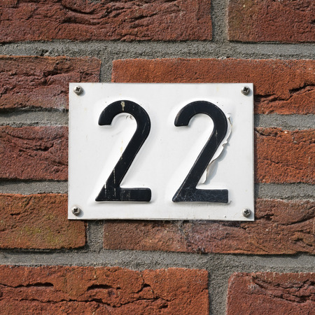 House number twenty two on a red brick wallの写真素材