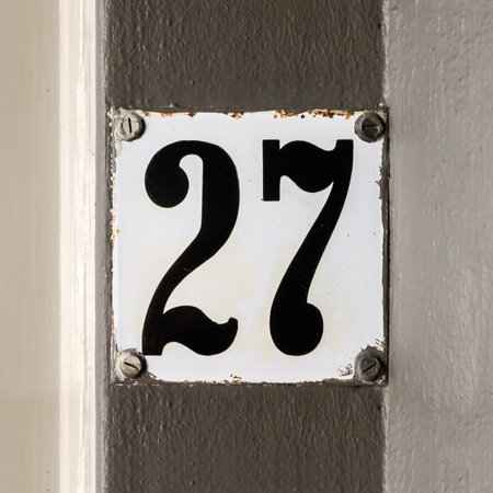 Enameled house number twenty seven.