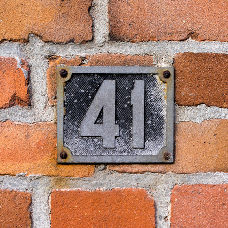 cast metal house number on a red brick wallの写真素材