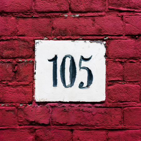 House number one hundred and five, carved in stoneの写真素材