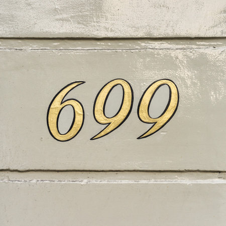 gold colored house number six hundred and ninety nine
