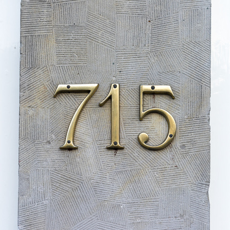 gold colored house number seven hundred and fifteenの写真素材