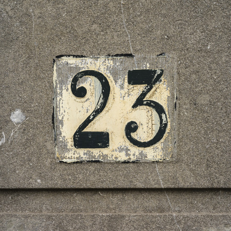 House number twenty three, hand painted on a concrete wallの写真素材