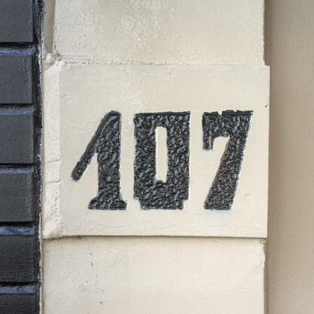 House number one hundred and seven, engraved in stone.の写真素材