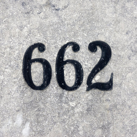 House number six hundred and sixty two, hand painted on a stone wall